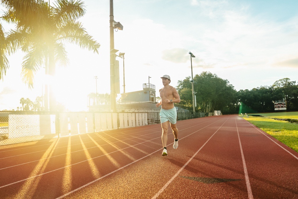 Running on a sunlit track in the early morning